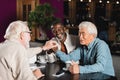 happy senior multiethnic friends joining hands Royalty Free Stock Photo