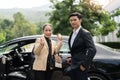 Happy senior old asian businesswoman and young asian male colleague at car park Royalty Free Stock Photo