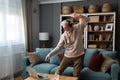 Happy senior old grandfather man in wireless headphones dancing, singing at home, choosing favorite energetic disco music in Royalty Free Stock Photo