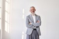 Happy senior older business man wearing suit standing isolated on white wall. Royalty Free Stock Photo