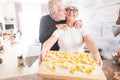 Happy senior people enjoying home indoor activity cooking italian tortellini healthy hand made pasta food - concept of lockdown