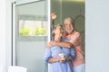 Happy senior people at home in retired lifestyle - active seniors smile and hug with love and relationship - indoor leisure