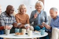 Happy senior people playing cards at nursing home Royalty Free Stock Photo