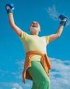 Happy Senior sportive man in boxing stance doing exercises with boxing gloves. Boxing. Active leisure. Fighter. Senior