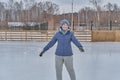 Happy senior white woman skating on skating rink and smiling in park in winter. Royalty Free Stock Photo