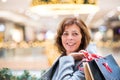 A happy senior woman doing Christmas shopping. Royalty Free Stock Photo