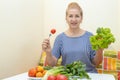 Happy senior woman eating fresh salad. Royalty Free Stock Photo