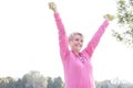 Happy senior woman exercising with dumbbells in park Royalty Free Stock Photo