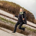 Happy senior woman frolicking on the beach