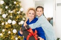 Happy senior woman giving christmas surprise to little girl at home. Excited granddaughter unpacking present under Royalty Free Stock Photo