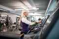 A senior woman in gym doing cardio work out exercise. Royalty Free Stock Photo