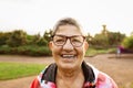 Happy senior woman having fun smiling in front of camera after training activity in a park Royalty Free Stock Photo