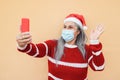 Happy senior woman having video call on mobile phone with santa claus hat - Focus on face Royalty Free Stock Photo