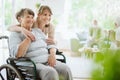 Senior woman and helpful caregiver, nursing home concept photos
