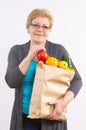 Happy senior woman holding shopping bag with fruits and vegetables, healthy nutrition in old age Royalty Free Stock Photo