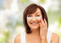 Happy senior woman with hydrogel under-eye patches
