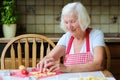 Happy senior woman making cookies at the kitchen Royalty Free Stock Photo