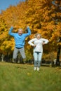 Happy senior woman and man in park jumping Royalty Free Stock Photo