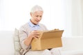 Happy senior woman with parcel box at home Royalty Free Stock Photo