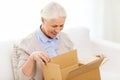 Happy senior woman with parcel box at home Royalty Free Stock Photo