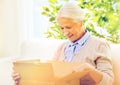 Happy senior woman with parcel box at home Royalty Free Stock Photo