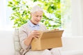 Happy senior woman with parcel box at home Royalty Free Stock Photo