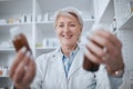 Happy senior woman, pharmacist and medicine for inventory inspection or checking stock on shelf at store. Mature female Royalty Free Stock Photo