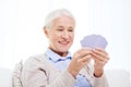 Happy senior woman playing cards at home Royalty Free Stock Photo