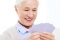 Happy senior woman playing cards at home Royalty Free Stock Photo