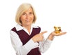 Happy senior woman pointing to piggy bank Royalty Free Stock Photo