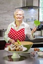 Happy senior woman baking in a bright modern kitchen