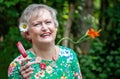 Happy senior woman with popsicle during summer