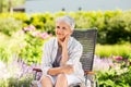 Happy senior woman resting at summer garden Royalty Free Stock Photo