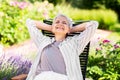 Happy senior woman resting at summer garden Royalty Free Stock Photo