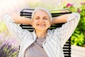 Happy senior woman resting at summer garden Royalty Free Stock Photo