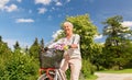 Happy senior woman riding bicycle at summer park Royalty Free Stock Photo