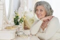 Happy senior woman sitting near dressing table Royalty Free Stock Photo