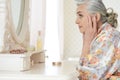 Happy senior woman sitting near dressing table Royalty Free Stock Photo