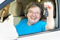 Happy Senior Woman Sitting In New Car Holding The Keys Royalty Free Stock Photo