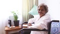 Happy senior woman sitting in wheelchair at nursing home Royalty Free Stock Photo