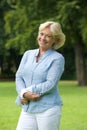 Happy senior woman smiling in the park Royalty Free Stock Photo