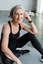 happy senior woman in sportswear listening Royalty Free Stock Photo