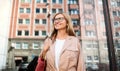 Happy senior woman standing outdoors in city or town park. Royalty Free Stock Photo