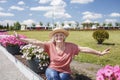 Happy senior woman in straw hat walking in park at sunny day, age beauty, baby boomer generation Royalty Free Stock Photo