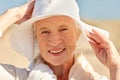 Happy senior woman in sun hat on summer beach Royalty Free Stock Photo