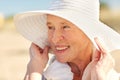 Happy senior woman in sun hat on summer beach Royalty Free Stock Photo