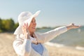 Happy senior woman in sun hat on summer beach Royalty Free Stock Photo