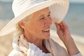 Happy senior woman in sun hat on summer beach Royalty Free Stock Photo