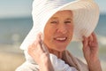 Happy senior woman in sun hat on summer beach Royalty Free Stock Photo