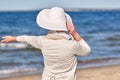 Happy senior woman in sun hat on summer beach Royalty Free Stock Photo